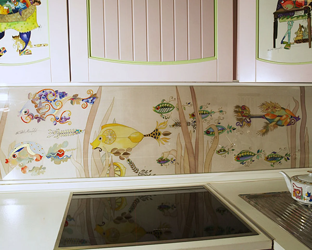 Kitchen splashback of painted silk showing fish and water plants, set into a pale hand-painted kitchen
